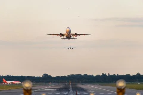 View directly down the runway as an easyJet Airlines plane takes off Stock Photos