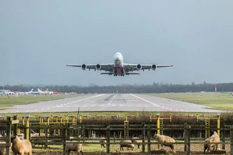 View directly down the runway as an Emirates Airline plane takes off Stock Photos