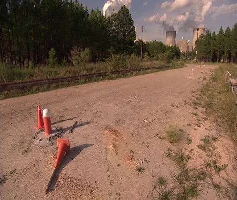 View of dirt road and long shot of Vogtle Electric Generating Plant Stock Footage 86693407