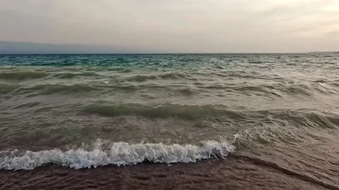 View of the dirty waves of the sea hitting the shore Stock Footage 317168232