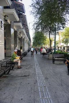 View of disability friendly sidewalk facilities with tactile paving tiles Stock Photos