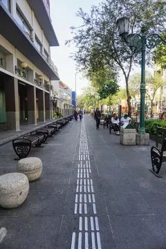 View of disability friendly sidewalk facilities with tactile paving tiles Stock Photos