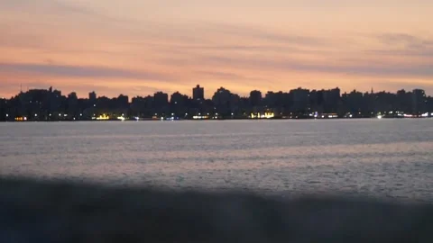 View of a Distant City by the Sea in the Evening with Moving Focus Stock Footage 243941814