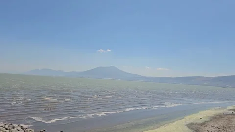 View of Distant Mountains Across the Lake Stock Footage 283595185