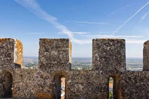 View of the distant plains and clear blue sky framed by the weathered, moss-c Foto stock