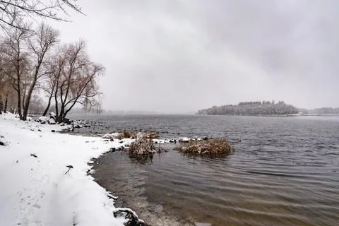View of the Dnieper river during a cold and snowy winter day. Stock Photos