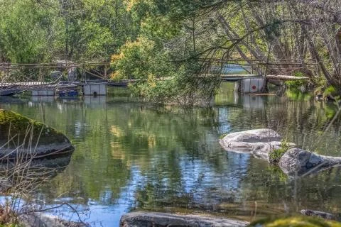 View Do river with ecological bridge, made with recycled materials Stock Photos