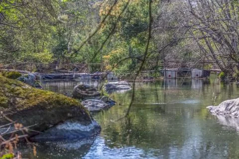 View Do river with ecological bridge, made with recycled materials Stock Photos