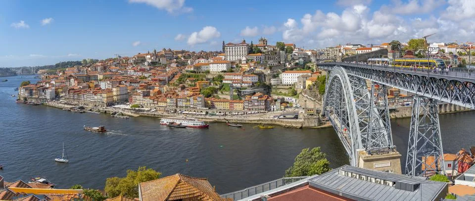 View of the Dom Luis I bridge over Douro River and terracota rooftops, UNESCO Stock Photos