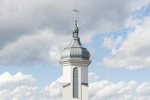 View of the dome and bell tower of a modern Catholic church against a blue sk Stock Photos