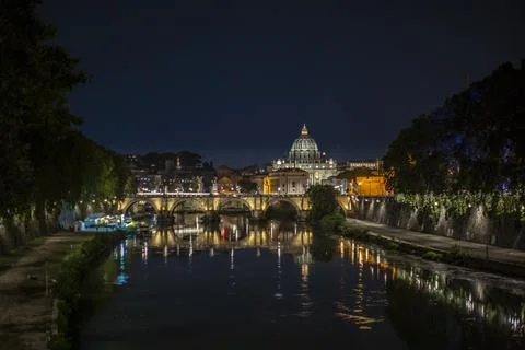 View of the dome of Saint Peter at night together with the Tiber river Stock Photos