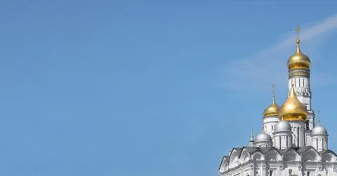 View of the domes and bell tower of an Orthodox church against the blue sky.  Stock Photos