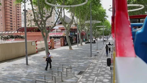 A view from double-decker tourist bus traveling along central avenue of Benidorm Stock Footage 333900194