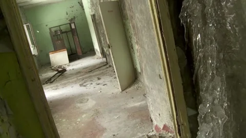 View Down an Abandoned Hallway with Severe Decay and Ice Formations on the Walls Stock Footage 321290110
