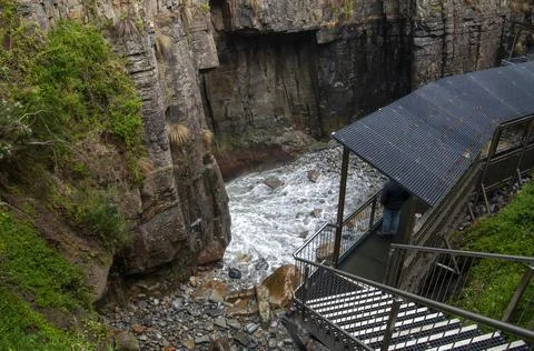 View down access stairs and water rushing through the remarkable cave Stock Photos