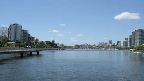 View down Brisbane River towards New Farm, people walking Riverwalk boardwalk Stock-Footage 231084387