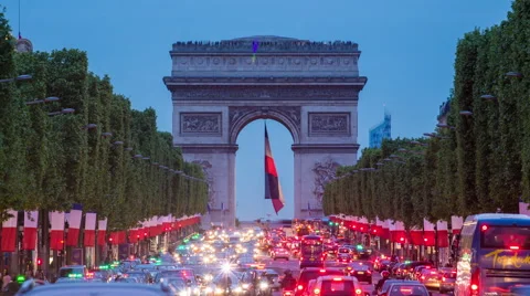 View down the Champs Elysees to the Arc de Triomphe, illuminated at dusk, Paris Stock Footage 54131999