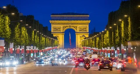 View down the Champs Elysees to the Arc de Triomphe, illuminated at dusk, Paris Stock Footage 106639390
