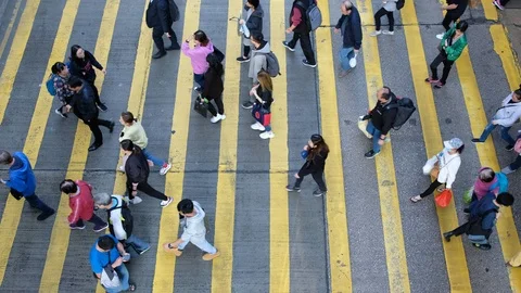 View down to crosswalk throng crowdy people flow crossing the street Stock Footage 104073171