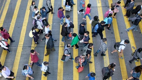 View down to crosswalk throng crowdy people flow crossing the street Stock Footage 104073207