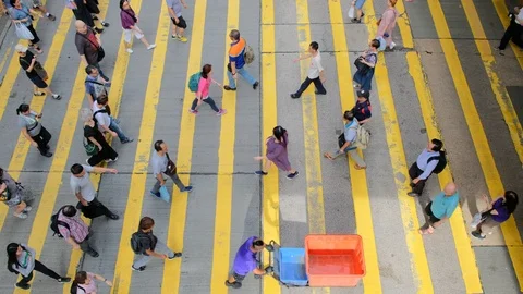 View down to crosswalk throng crowdy people flow crossing the street Stock Footage 115347637