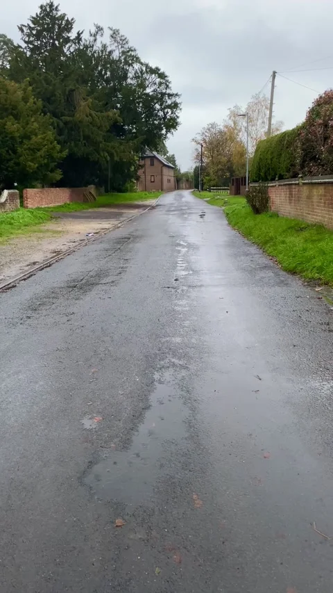 View down a lane on a rainy day Stock Footage 255510160