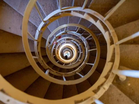 View down in Minaret tower to visitor going down by rotating stairs View d... 库存照片