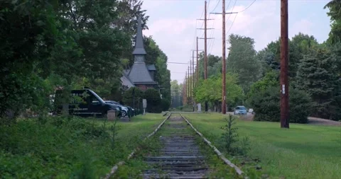 View down the Old Train Track with cars crossing, Demarest, New Jersey. 4K Stock Footage 156052311