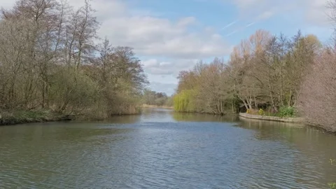 View down the River Bure, Norfolk Broads. Panning shot Stock Footage 332222363