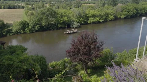View down to the River Dordogne, watching a Gabarres pleasure boat trip go past Stock Footage 302471802