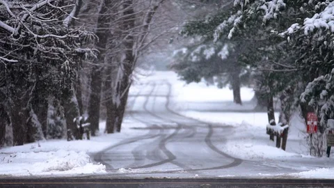 View down a side street as snow falls, in slow motion Video stock 89663195