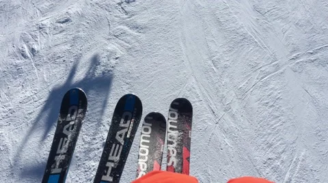 View down on skis on a chairlift with shadow of other chairlift Park City Utah Stock Footage 61863533