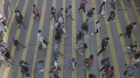 View down to Slow motion crosswalk throng crowdy people flow crossing the street Stock Footage 104073242