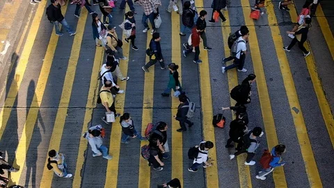 View down to Slow motion crosswalk throng crowdy people flow crossing the street Stock Footage 104073340