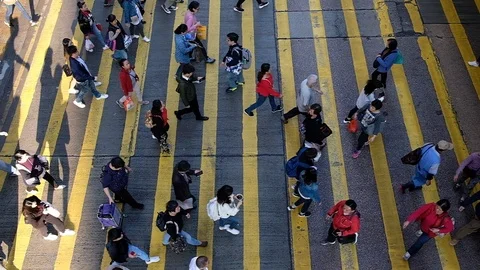 View down to Slow motion crosswalk throng crowdy people flow crossing the street Stock Footage 104073415