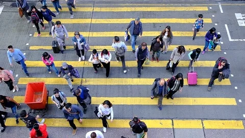 View down to Slow motion crosswalk throng crowdy people flow crossing the street Stock Footage 104073655
