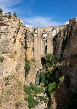 View down the steep rockface to valley in Ronda Stock Photos