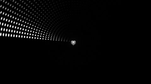 View down a tunnel with light at the end and dotted pattern Stock Footage 339327949