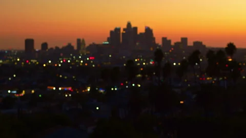 View of downtown stunning sunset over skyscrapers with city lights Los Angeles Stock Footage 275451443