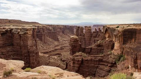 View of dramatic canyons with towering rock formations and cloudy sky in th.. Stock Photos