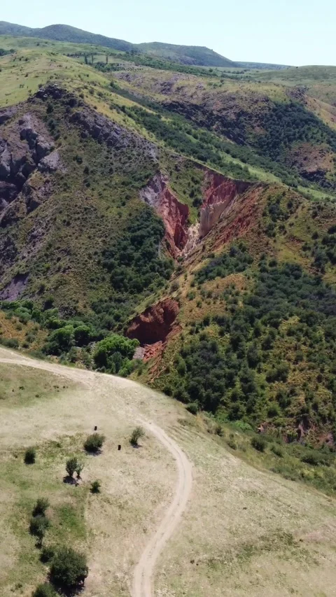 View of dramatic volcanic rock canyon and unpaved country trails in Kazakhstan Stock Footage 338127435