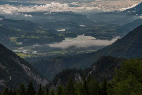 View on Drau river valley from path to Mittagskogel hill in cloudy summer day Stock Photos