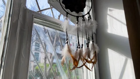 View of a dream catcher hanging in a window Stock Footage