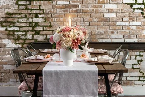 View of dreamy cute table decor with glasses flowers and lit candles. Wedding Stock-Fotos