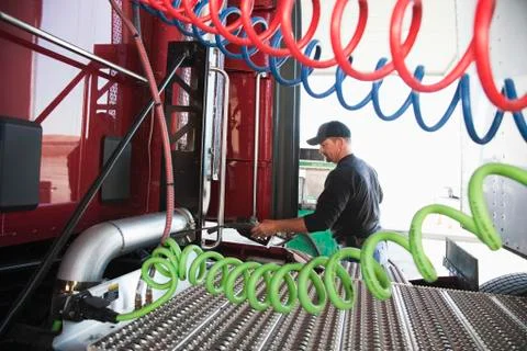 View of a driver putting gas in a commercial truck. Stock Photos