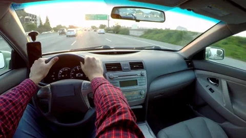 View of the driver's hand on the steering wheel of a car that is driving on the Stock-Footage 336267955