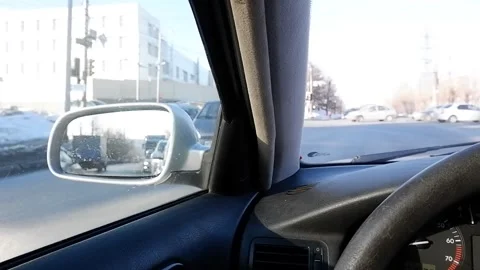 View from the driver's seat of the car at the intersection.Reflection of cars in Stock Footage 172107050