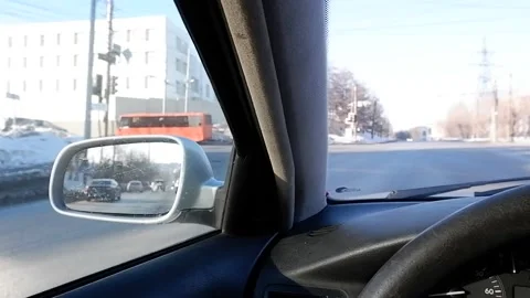 View from the driver's seat of the car at the intersection.Reflection of cars in Stock Footage 172107072