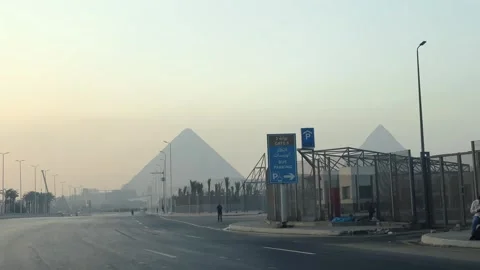 View from driving car of Giza Pyramids Rising above Urban Skyline Seen from Vídeos de archivo 341838462