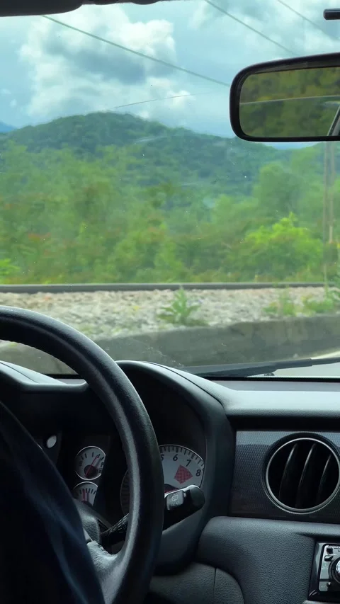 The view from the driving car on the road and mountains. Vertical video. Stock Footage 273192495